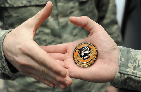 soldiers handing each other challenge coins