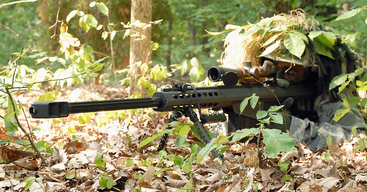 army sniper covered in foliage